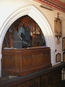 The old organ loft in the chancel, showing some of the Choir Organ pipes